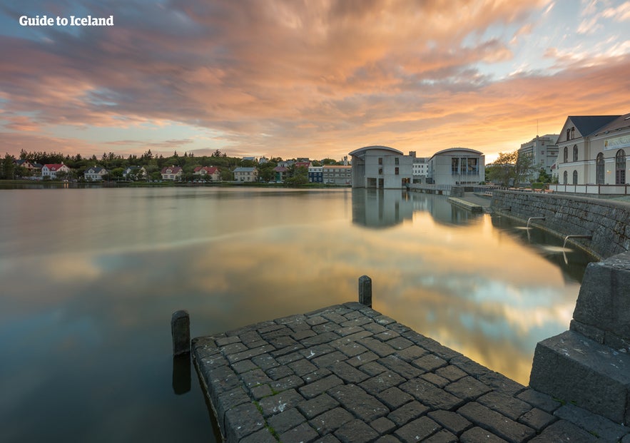 Reykjavík's famed Tjörnin lights up in summer, presenting an idyllic view of swans on the water