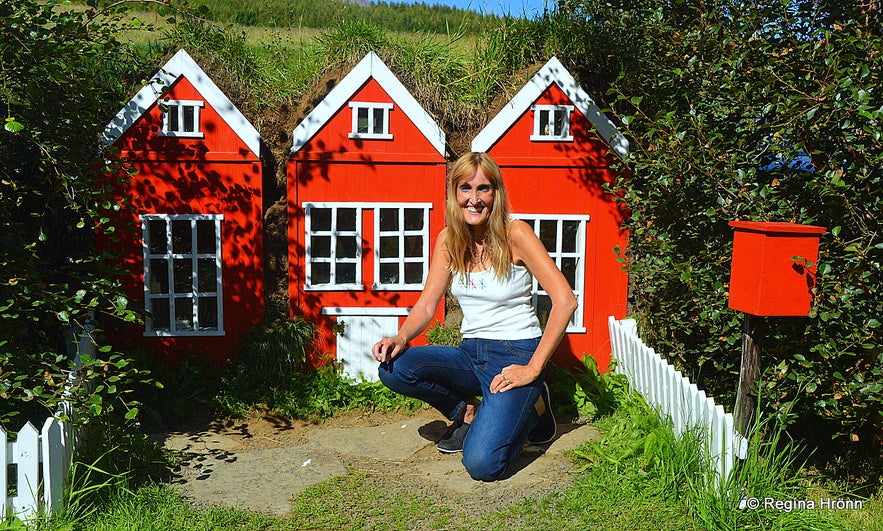 Regína by The miniature replica of a turf house by the Christmas House