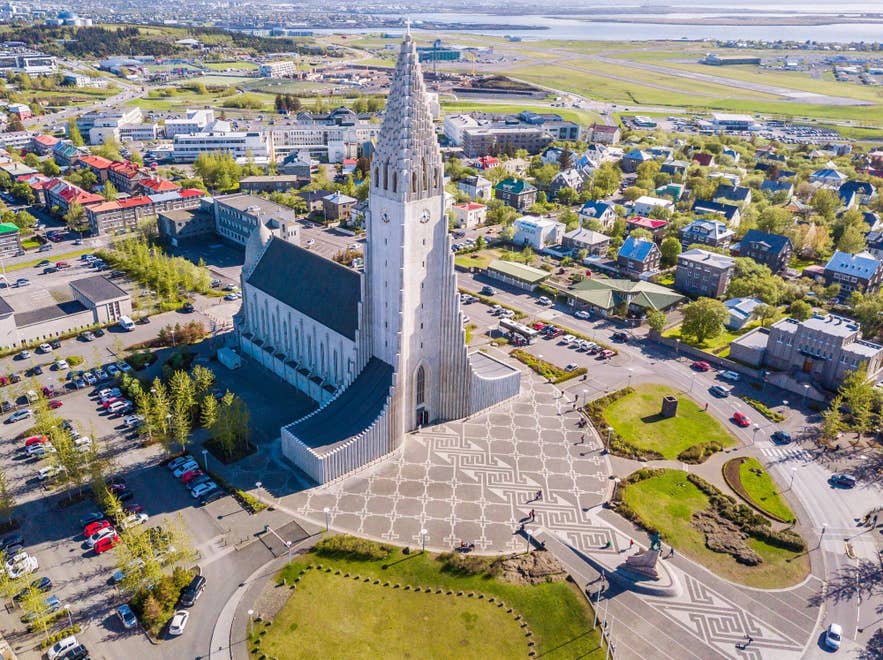 Aerial view of Hallgrimskirkja Church rising above colorful rooftops in central Reykjavik on a sunny day. Aerial view of Hallgrimskirkja Church rising above colorful rooftops in central Reykjavik on a sunny day.