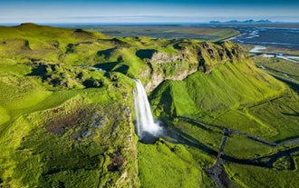 A picturesque waterfall, one of the stops on a South Coast sightseeing tour in Iceland.