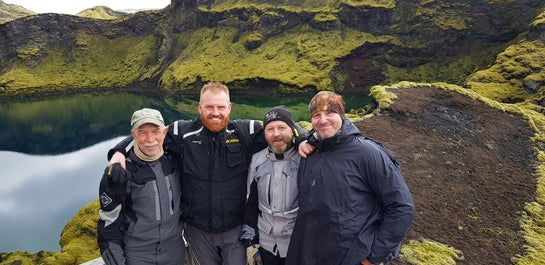 At a highland crater where moss and black rock contrast each other all around.