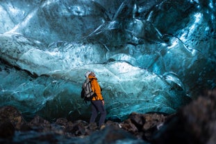 A tour joiner admiring the beautiful ice cave of Greenland.