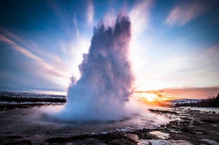 Strokkur geyser erupts with boiling water every few minutes.