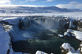 Godafoss waterfall thunders into a dramatic valley in winter in Iceland.