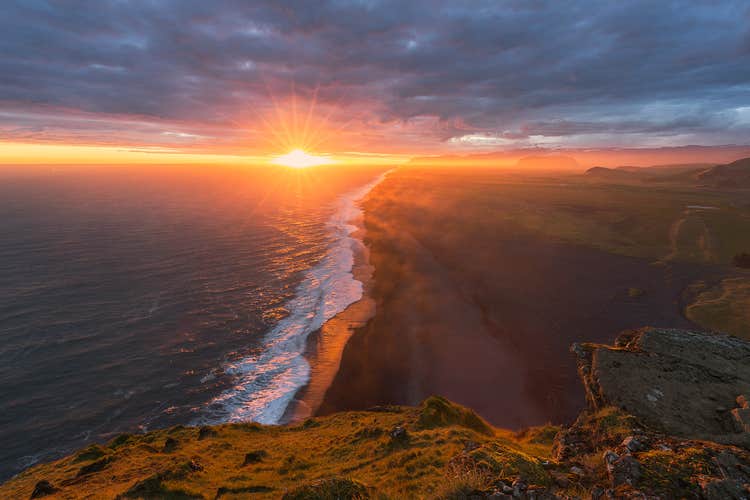 The black beach of Kirkjusandur stretching out on a summer night.