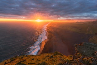 The black beach of Kirkjusandur stretching out on a summer night.