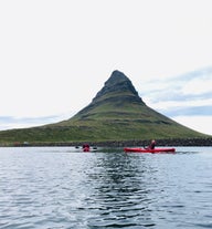 Der Berg Kirkjufell ist im Hintergrund zu sehen, während die Kajakfahrer fröhlich die Tour genießen