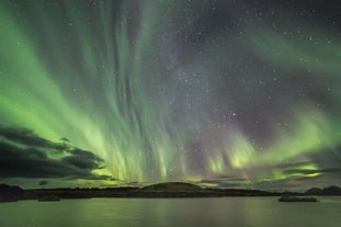 The northern lights shine in the sky over Lake Myvatn.
