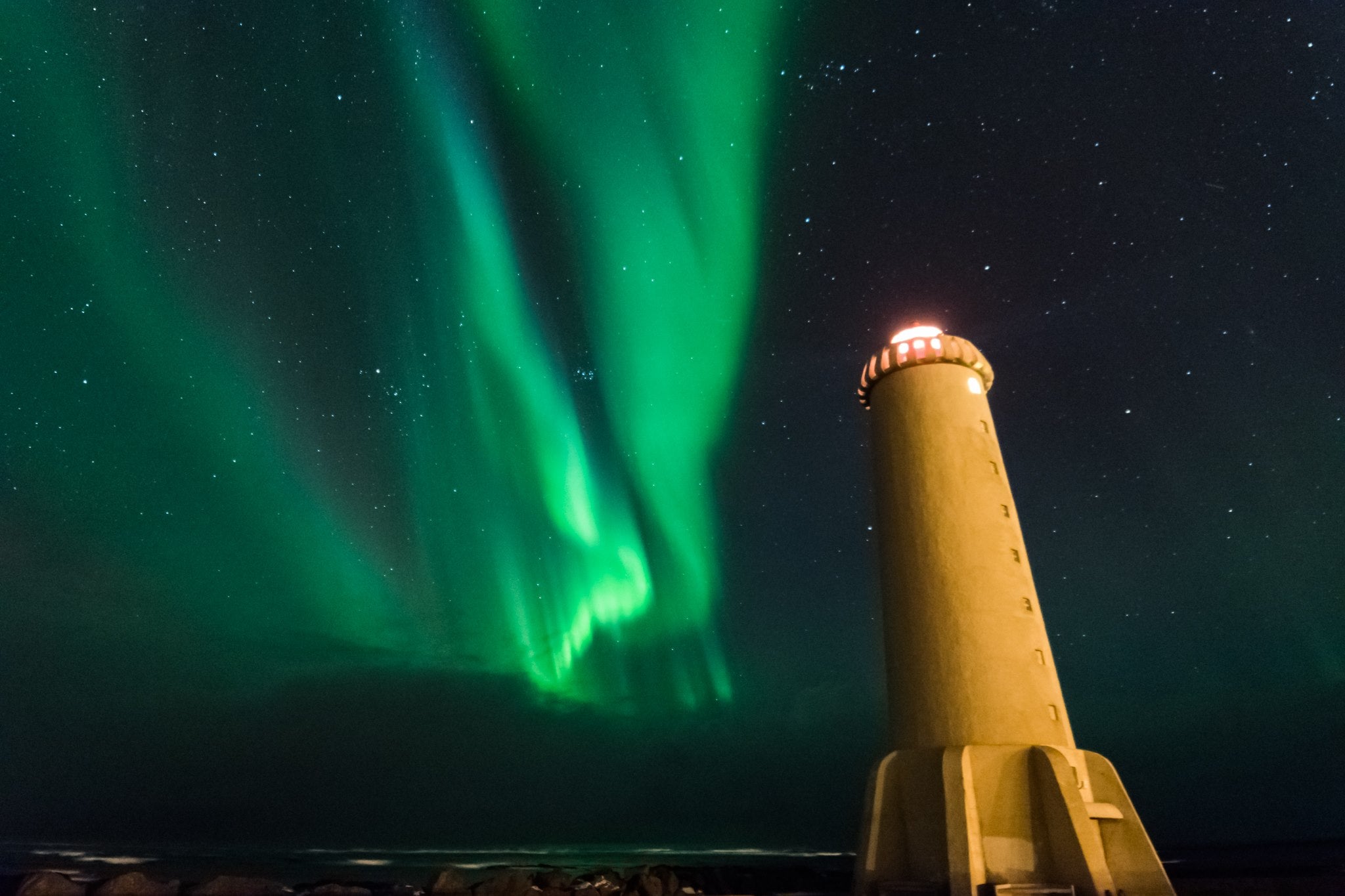 A beautiful lighthouse near Reykjavik pairs up with the beautiful aurora borealis.