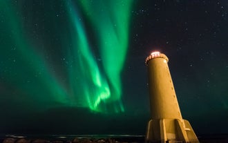 A beautiful lighthouse near Reykjavik pairs up with the beautiful aurora borealis.