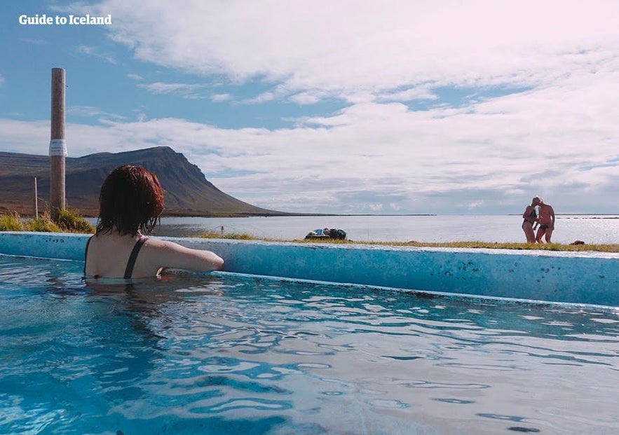 A woman looks at the views from her outdoor pool.