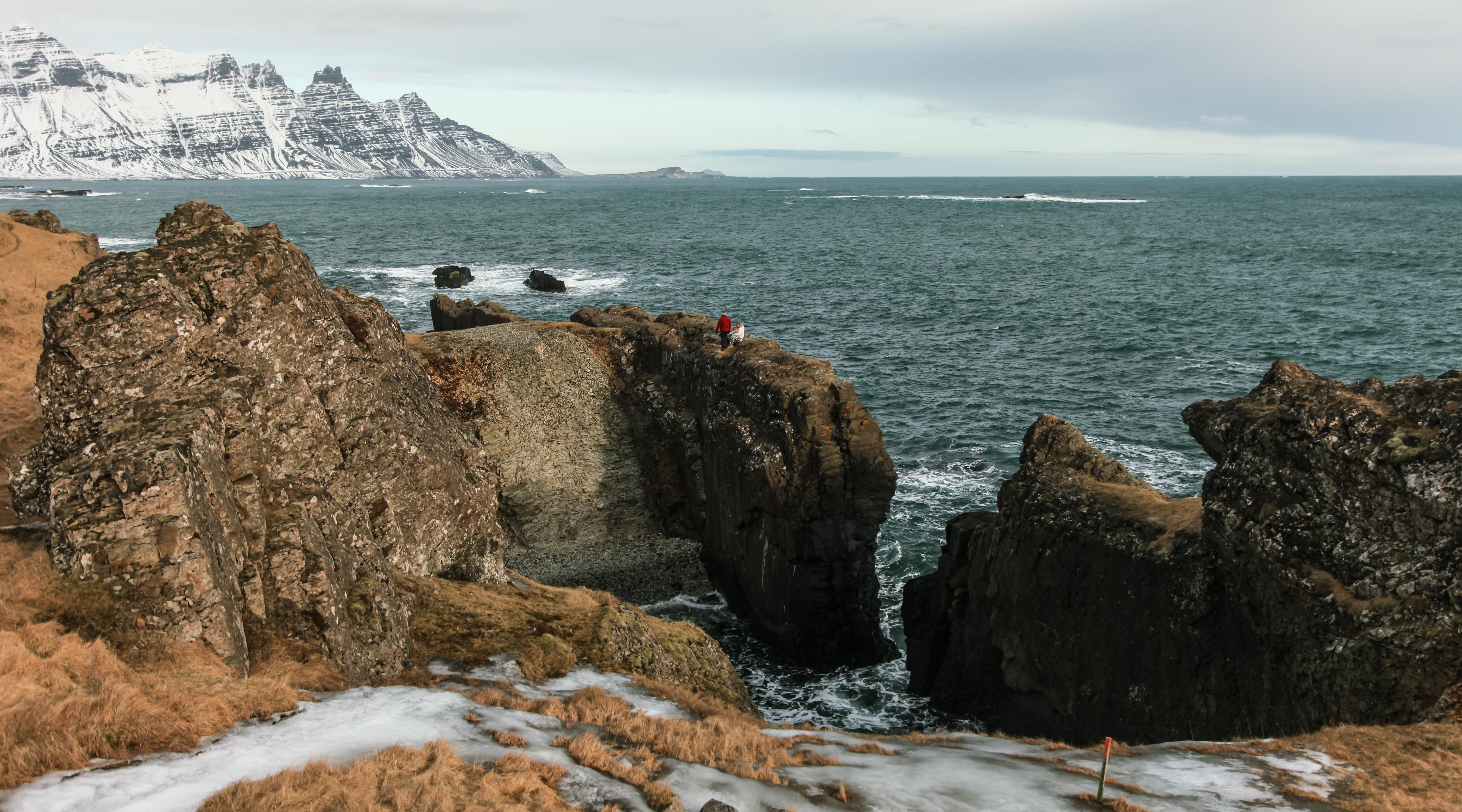 Dramatic view of Streiti Coastline in East Iceland, featuring rugged lava rocks, crashing waves, and panoramic ocean scenery.