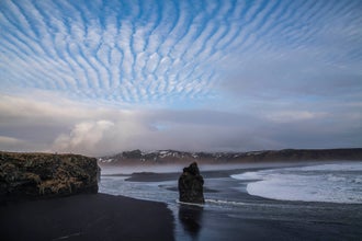 Reynisfjara black sand beach is famous for its ocean waves and cliffs.