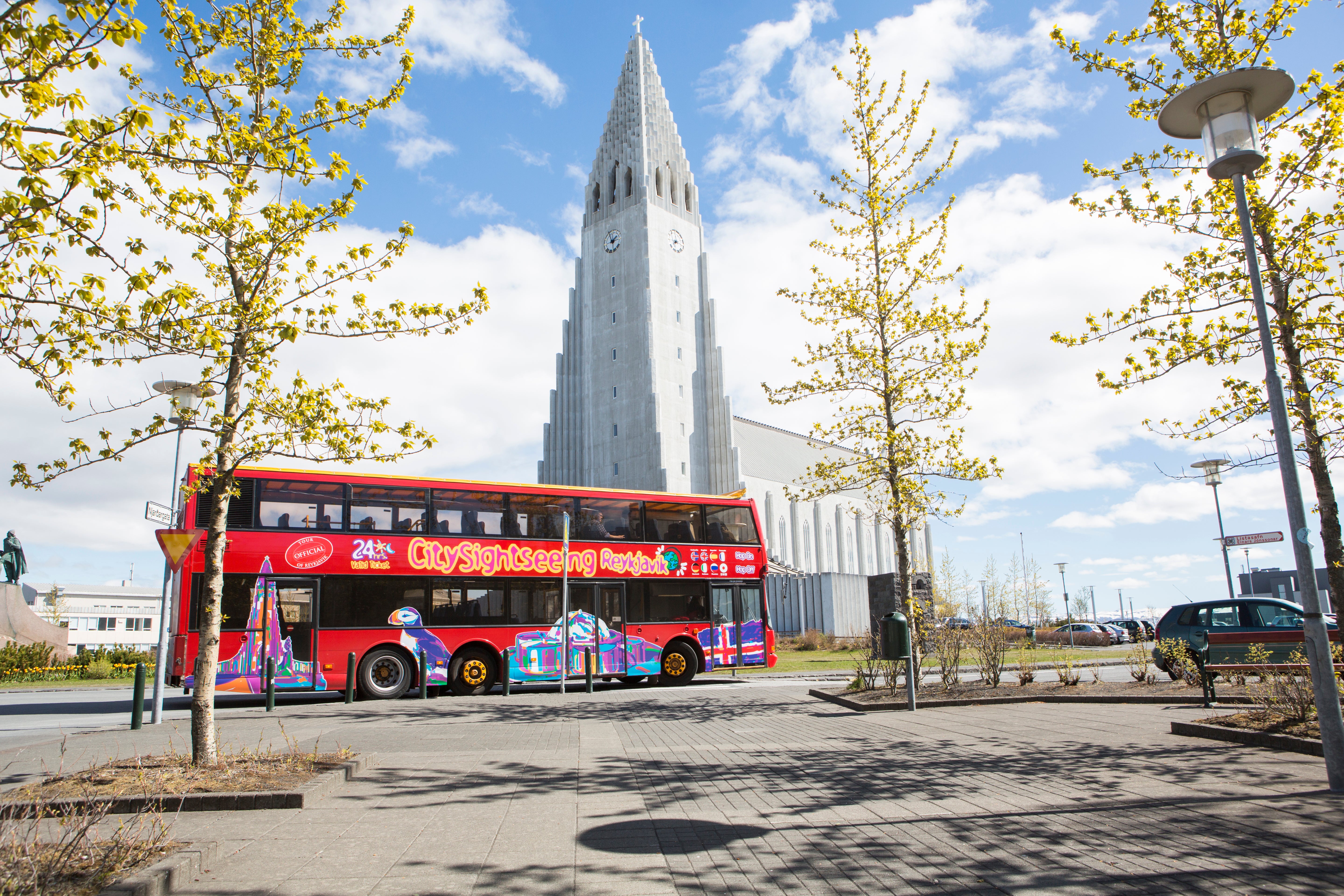 Reykjavik city sightseeing bus stopping near Hallgrimskirkja for visitors.