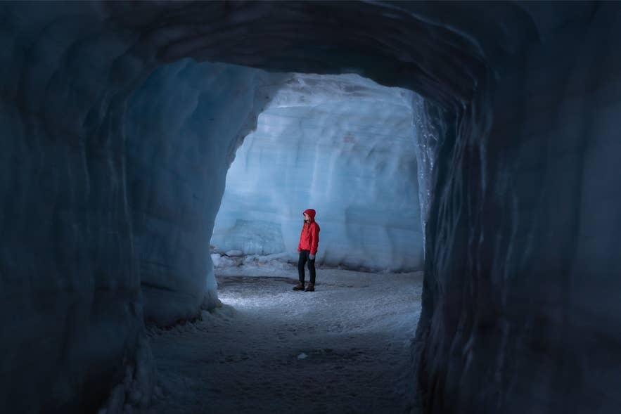 Een reiziger staat in de ijstunnel van Langjökull.