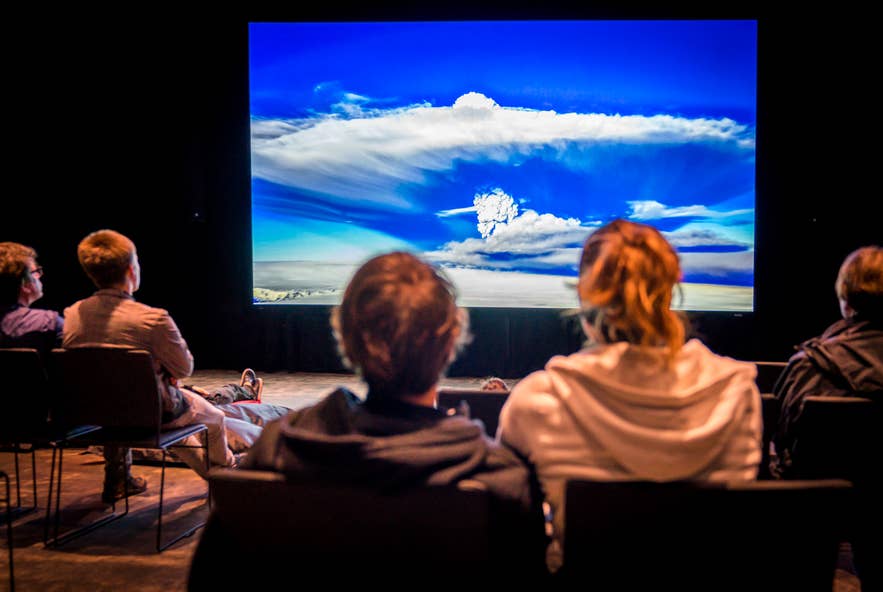Visitors watching a volcano exhibit at the LAVA Centre in Hvolsvollur.