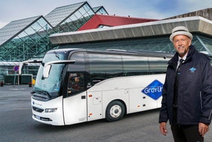 Our professional driver poses with one of our buses behind him.