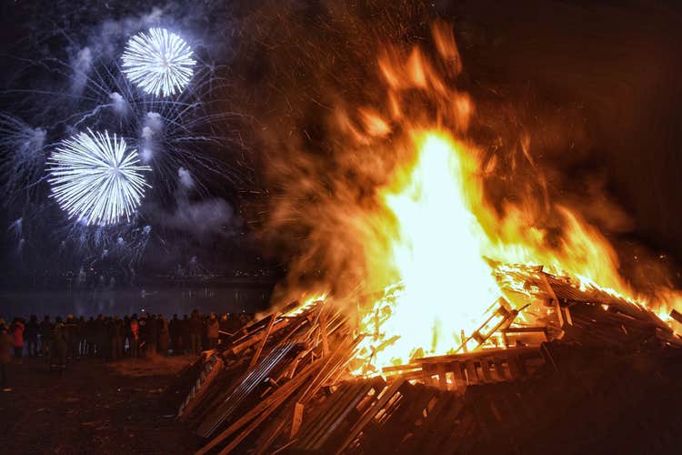 Bonfires create cosy light in a dark winter landscape