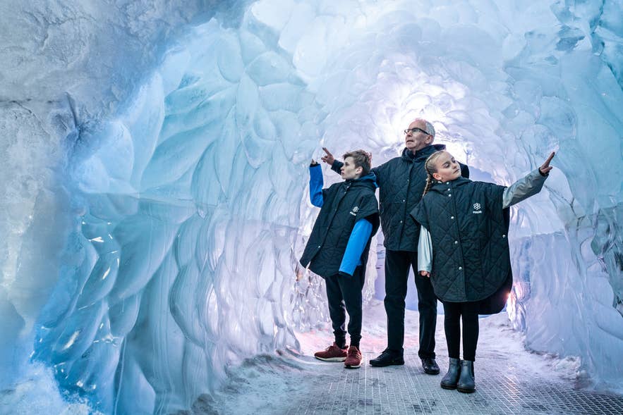 A family walking through the indoor ice cave at Perlan in Reykjavik