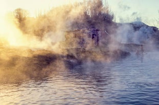 Steam rises from the geothermal waters of the Secret Lagoon geothermal spa.