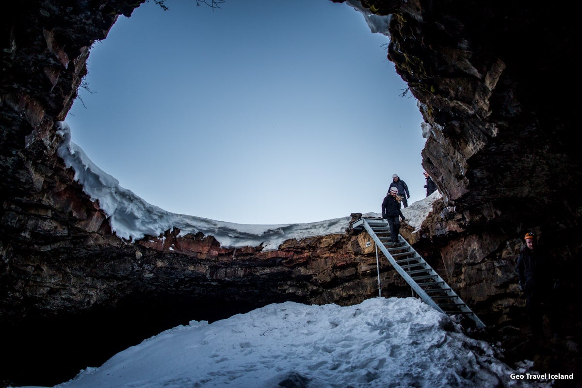 Guests going down the stairs on the mouth of the Lofthellir ice cave's entrance.