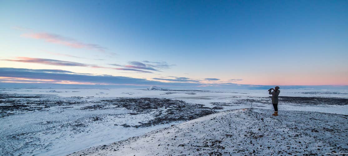 Watch as the first light delicately touches the snowy terrain, creating a serene and elegant winter morning scene.