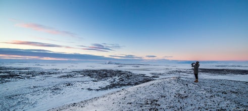 Watch as the first light delicately touches the snowy terrain, creating a serene and elegant winter morning scene.