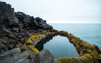 Brimketill, a lava rock pool perched on the edge of the ocean in Reykjanes Peninsula.