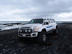 Rugged terrain meets the power of the super jeep on the black sands.