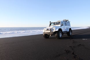 A super jeep on a black sand beach by the Atlantic Coast in South Iceland.