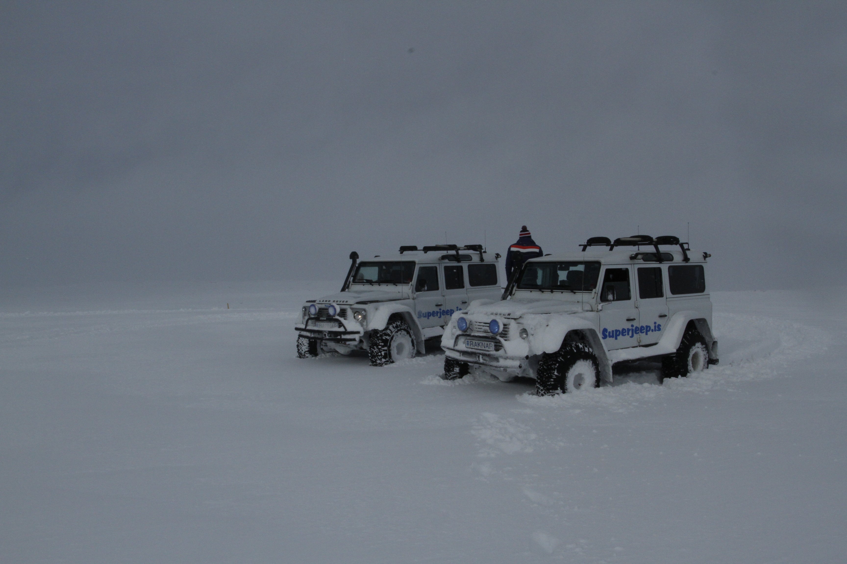 Two super jeeps parked in the snow in winter in Iceland.