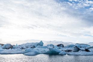 A picture of the glacier lagoon with ice chunks floating in it.