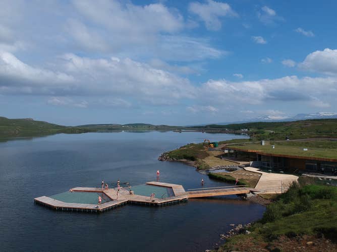 A view of Vok Baths facilities with two hot pools in the ocean and walking paths surrounding them.