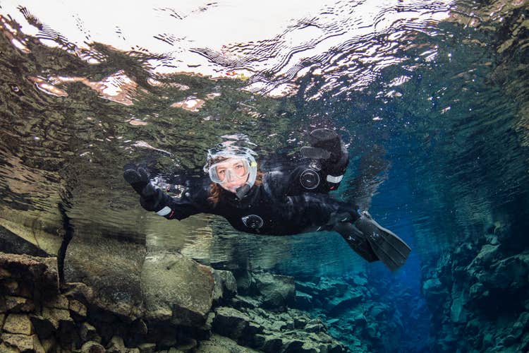 Woman snorkeling at Silfra in Thingvellir National Park