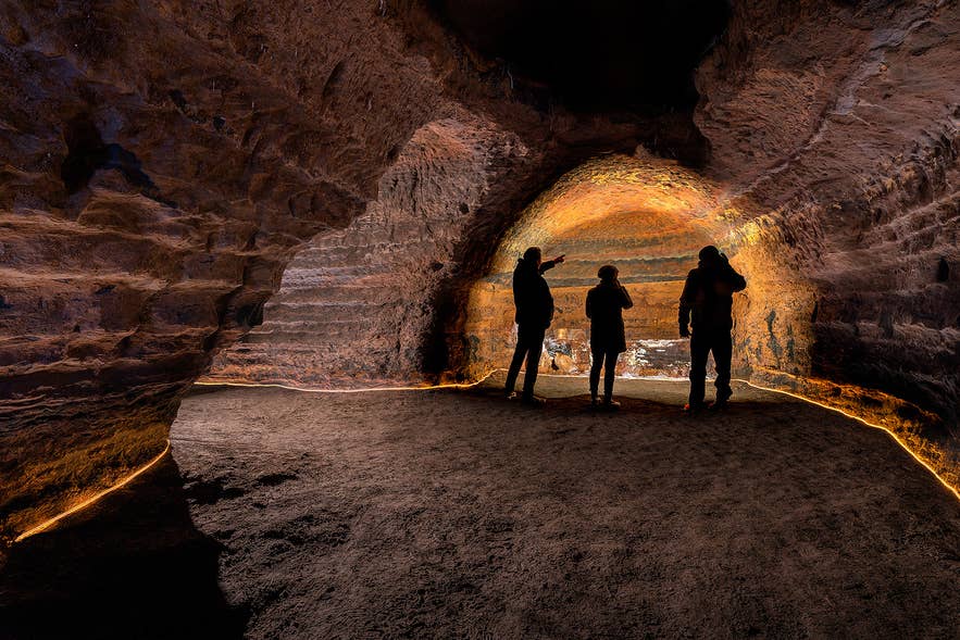 Visitors exploring the Caves of Hella in South Iceland