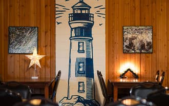A lighthouse artwork on the wall of the dining area at Fisherinn.
