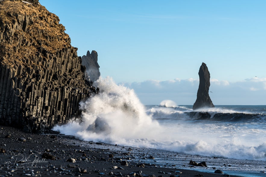 Big waves breaking on the basalt columns.