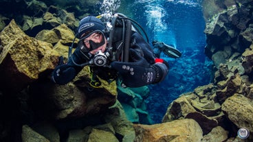 A person on a diving tour in Thingvellir National Park.