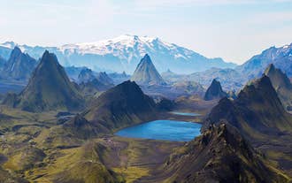 The spectacular landscapes of the Laugavegur Trail, with snow-capped mountains, beautiful lakes, and meandering rivers.