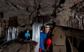 Exploring the ancient tunnels of Raufarholshellir lava tube is a thrilling experience.