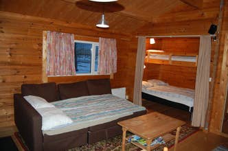 The double sofa bed, coffee table, double bed, and single bunk at Moar Cottage #2.