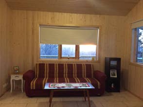 A cozy sofa in the living room of the Middalskot Cottage.
