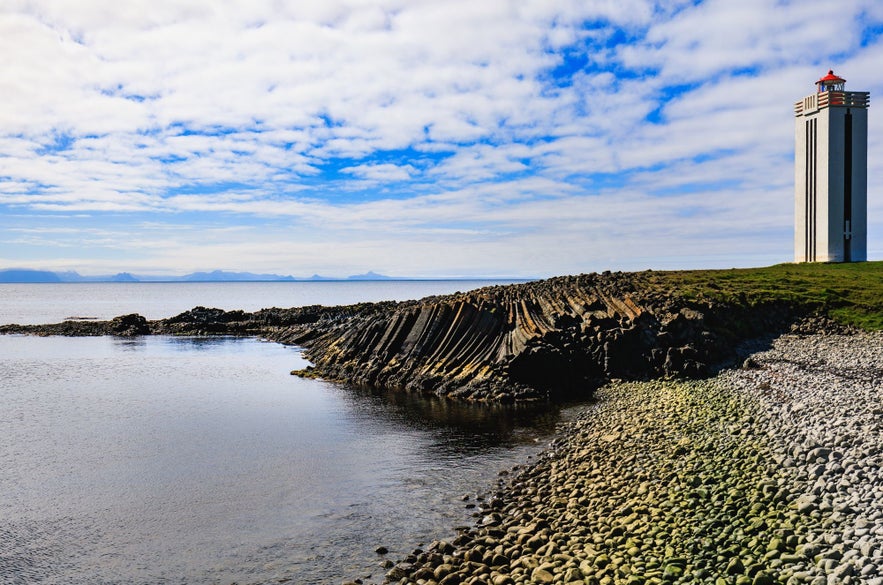 The lighthouse by Kalfshamarsvik towers over the beautiful basalt column coast