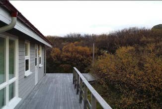 Patio view of the Stundarfridur 4 in West Iceland with trees surrounding the house.