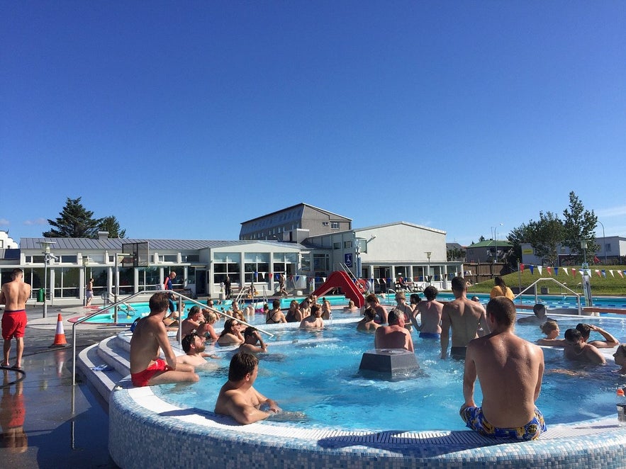 A group of people bathing in a local swimming pool in Iceland.