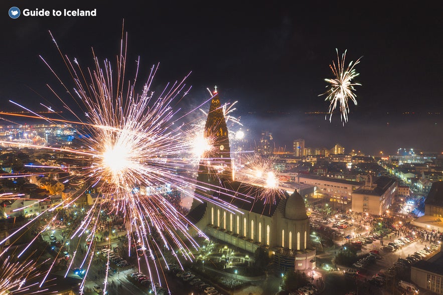 Hallgrimskirkja church in Reykjavik surrounded by fireworks on new years.