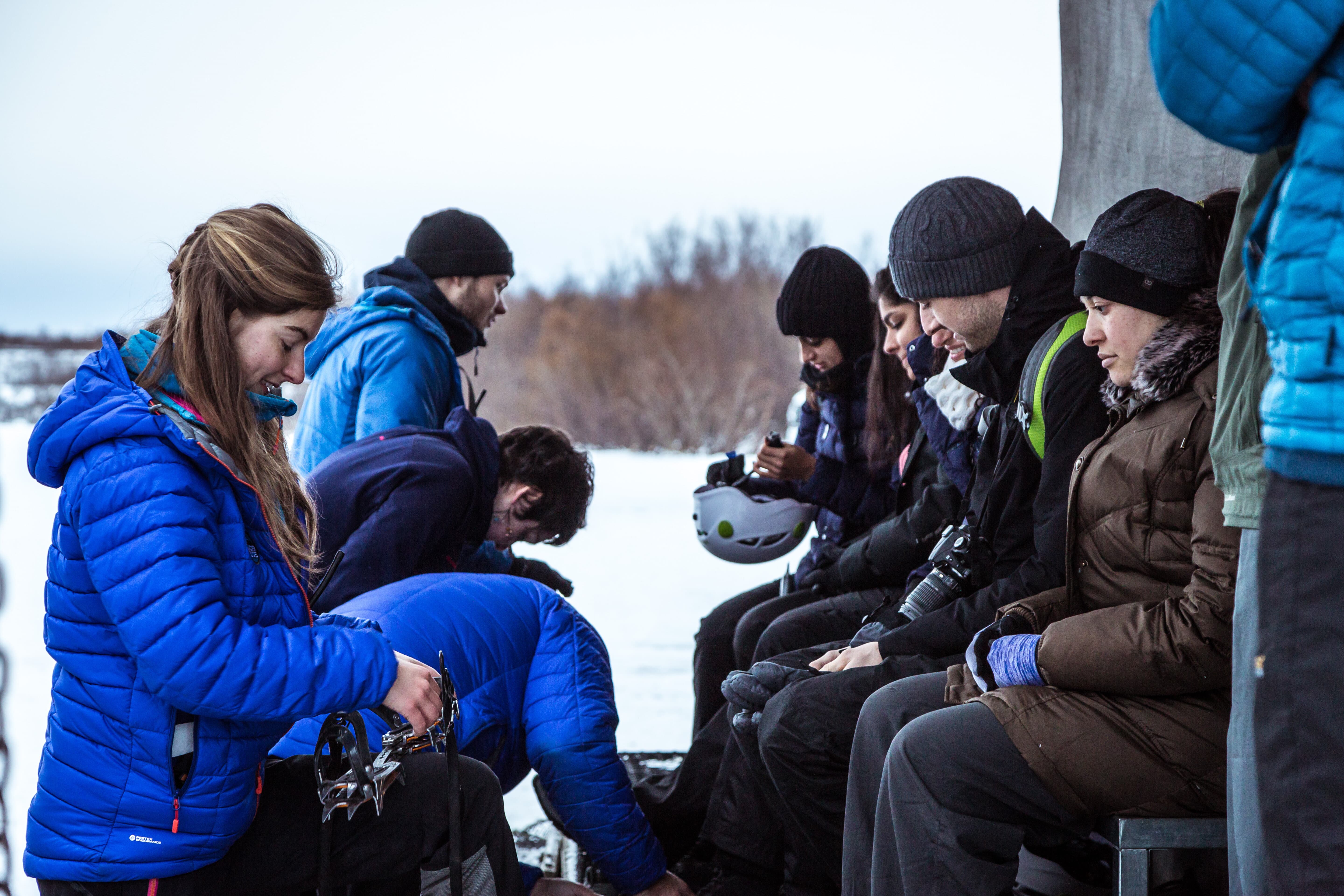 A group of people getting kit on for the glacier hike