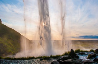 Seljalandsfoss waterfall viewed from behind at golden hour