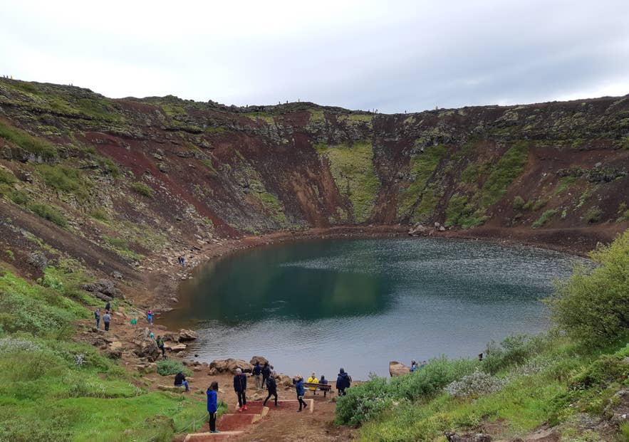 Visitors walking around the rim of Kerid crater on the Golden Circle Visitors walking around the rim of Kerid crater on the Golden Circle