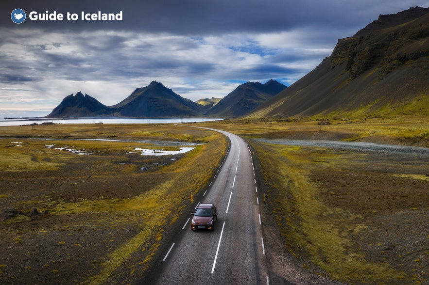 Vehicle driving on a road close to Eystrahorn in Iceland.